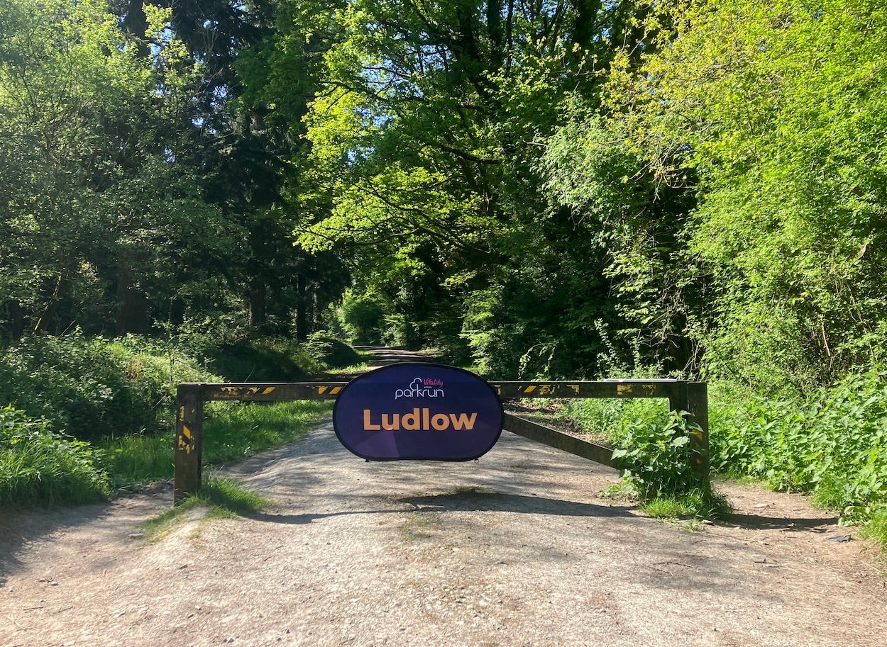 A metal barrier on which a "parkrun Ludlow" banner has been placed