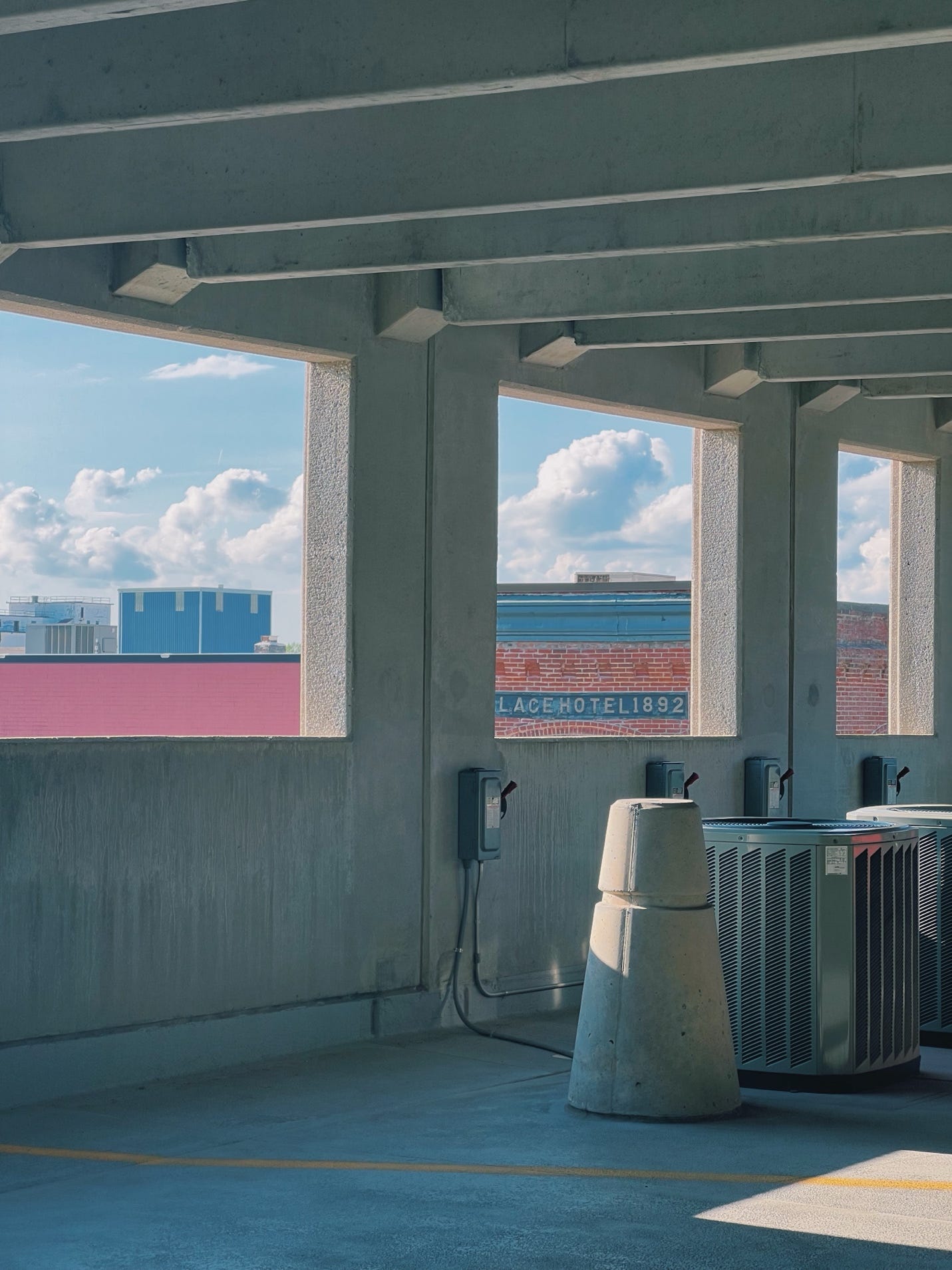 A concrete structure with a large window

AI-generated content may be incorrect.