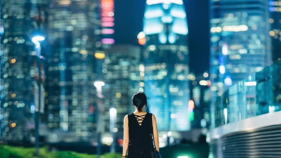 Rear view of woman looking towards downtown area of Hong Kong.