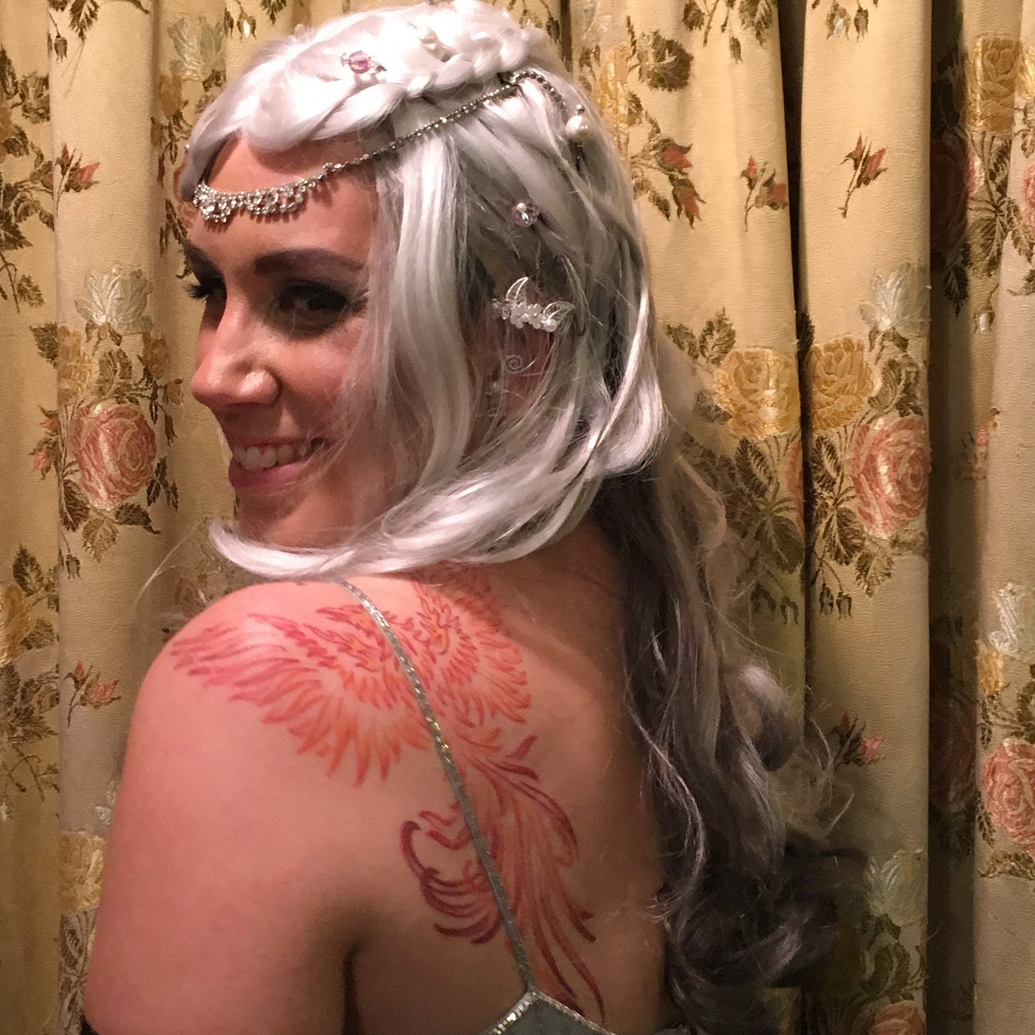 Sue as an elf princess with a phoenix logo on her shoulder; a professional headshot of Sue; Sue and her husband ice climbing together