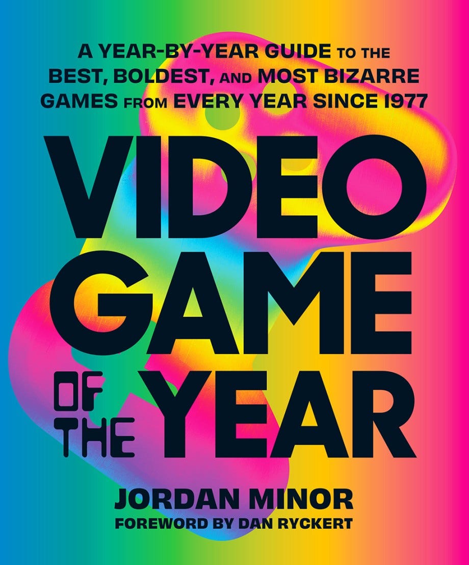 The cover of Video Game of the Year by Jordan Minor, which uses a rainbow's worth of swirling colors, with various controller shapes in the background.