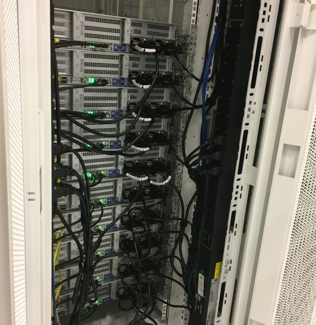 A rack inside Agoda’s Singapore data center. The yellow networking cables are 25 GPS, and the black ones are power cables