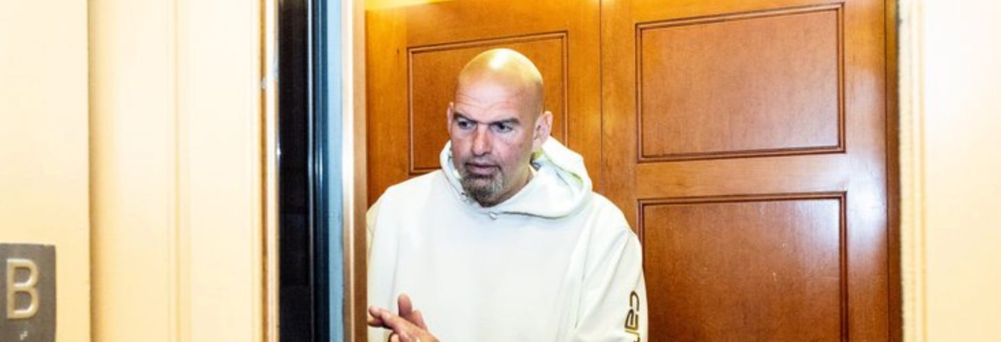 John Fetterman in a white Carhartt hoodie in a Senate elevator
