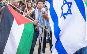 People stand with both the Israeli and Palestinian flags. 