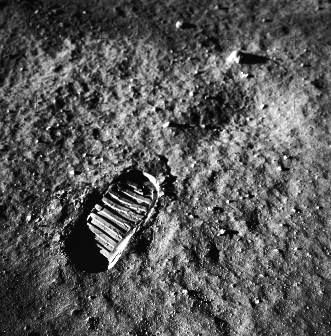 This is a close-up view of an astronaut’s footprint in the lunar soil, photographed by a 70 mm lunar surface camera during the Apollo 11 lunar surface extravehicular activity. The first manned lunar mission, the Apollo 11 launched aboard a Saturn V launch vehicle from the Kennedy Space Center, Florida on July 16, 1969 and safely returned to Earth on July 24, 1969. The 3-man crew aboard the flight consisted of Neil A, Armstrong, mission commander; Edwin E. Aldrin, Jr., Lunar Module Pilot; and Michael Collins, Command Module pilot. The LM landed on the moon’s surface on July 20, 1969 in the region known as Mare Tranquilitatis (the Sea of Tranquility).  Armstrong was the first human to ever stand on the lunar surface. As he stepped off the LM, Armstrong proclaimed, “That’s one small step for man, one giant leap for mankind”. He was followed by Edwin (Buzz) Aldrin, describing the lunar surface as Magnificent desolation.  Astronaut Collins piloted the Command Module in a parking orbit around the Moon. The crew collected 47 pounds of lunar surface material which was returned to Earth for analysis. The surface exploration was concluded in 2½ hours. With the success of Apollo 11, the national objective to land men on the Moon and return them safely to Earth had been accomplished. The Saturn V vehicle was developed by the Marshall Space Flight Center (MSFC) under the direction of Dr. von Braun.