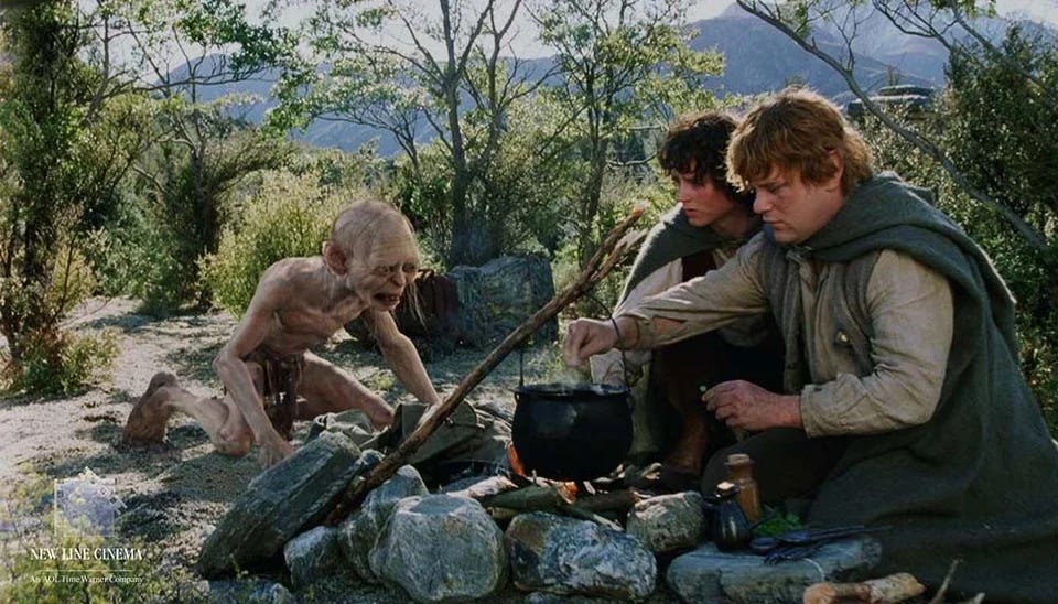 Sam cooks a stew while Frodo and Bilbo watch. From The Two Towers (2002)