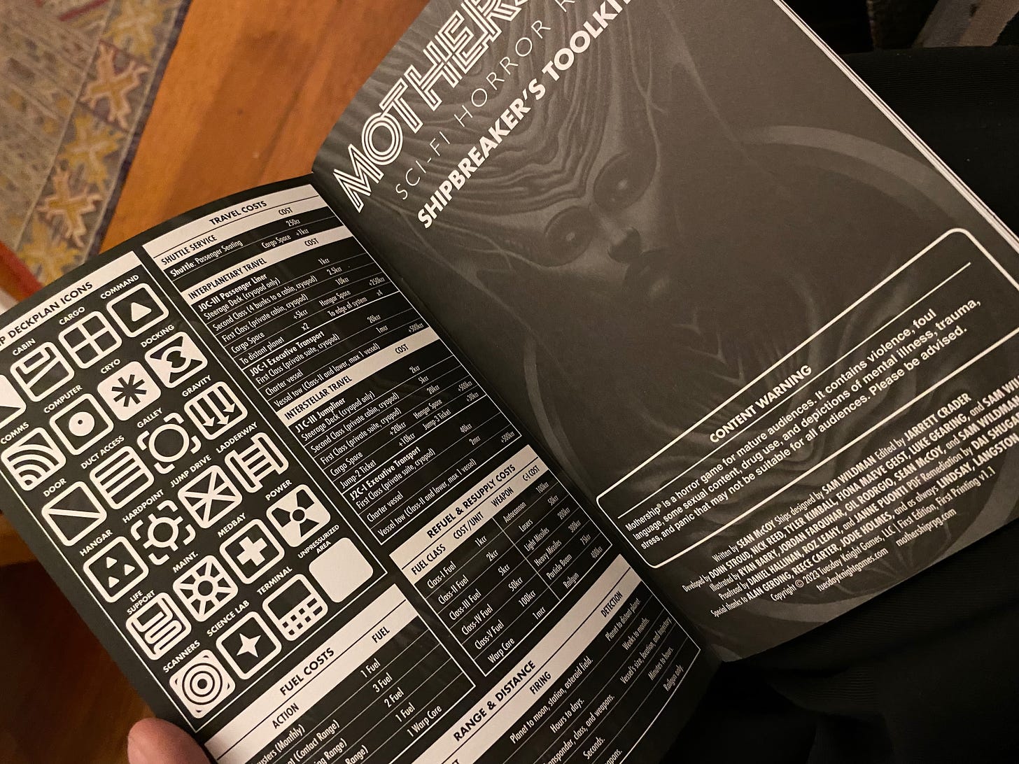 Photo of the Mothership Shipbreaker's Toolkit rulebook open on the first page, filled with diagrams for mapping starship deck plans