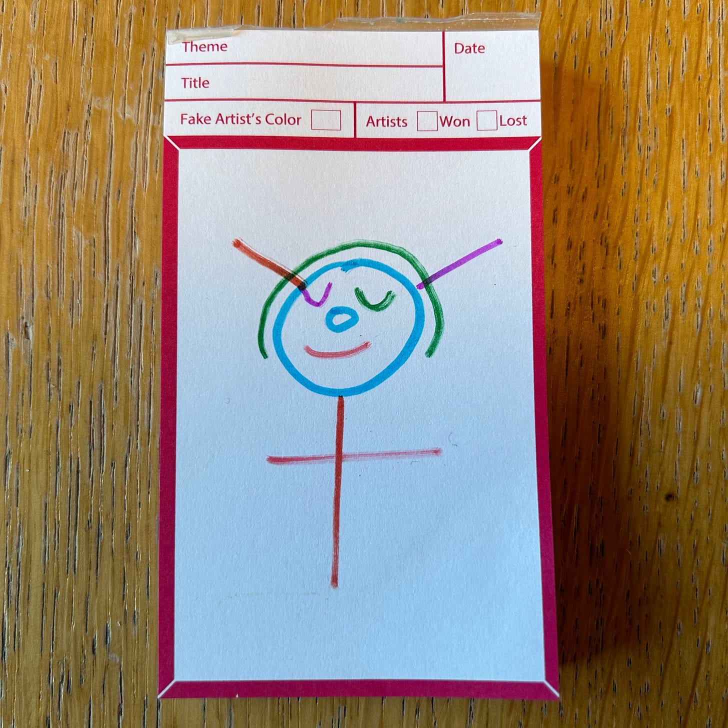 A pen drawing from the game A Fake Artist Goes to New York. It is a face and stick body. The eyes are closed. The face is smiling. It has two antlers.