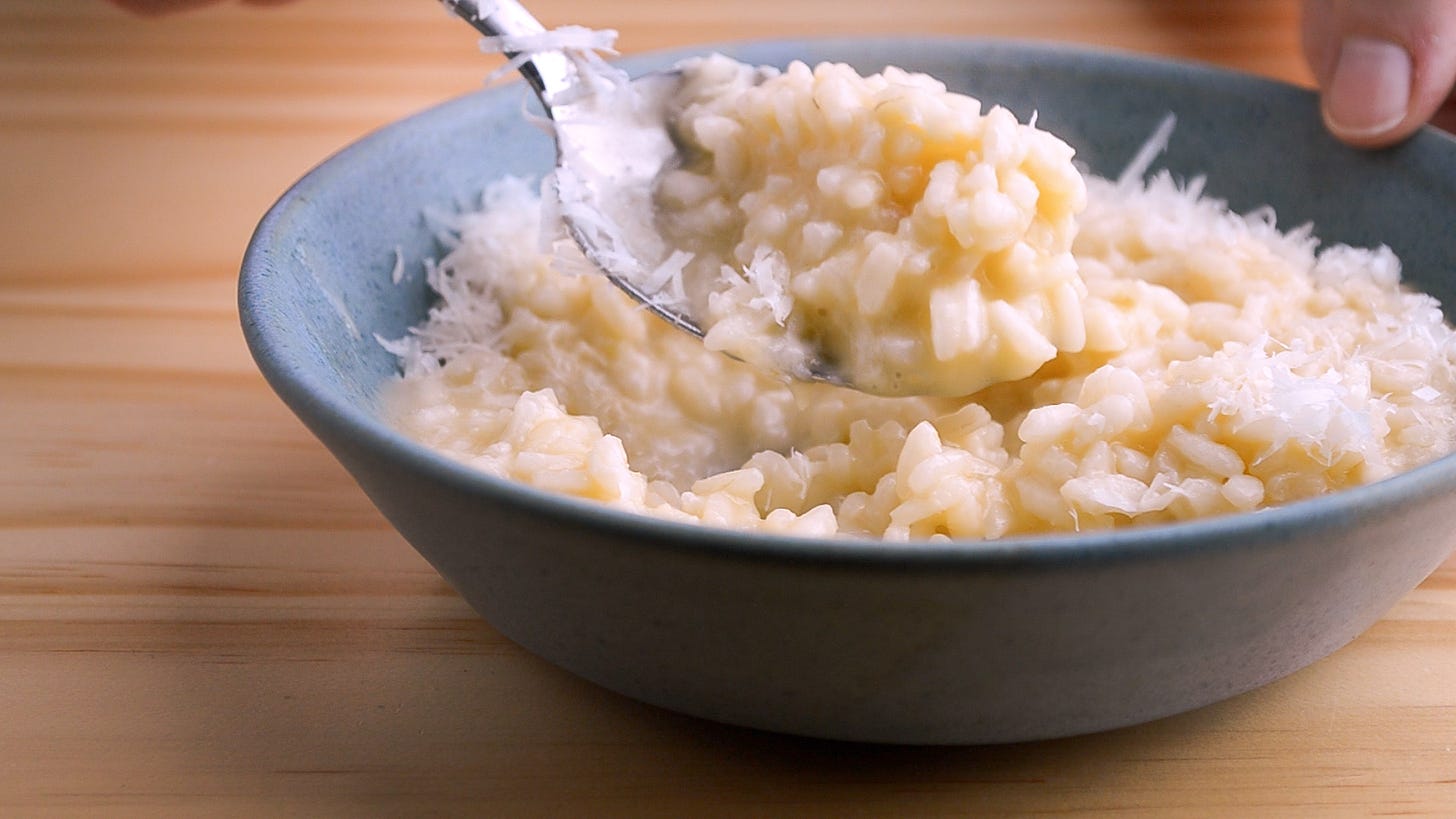 Close up picture of a spoonful of basic risotto sprinkled with cheese.