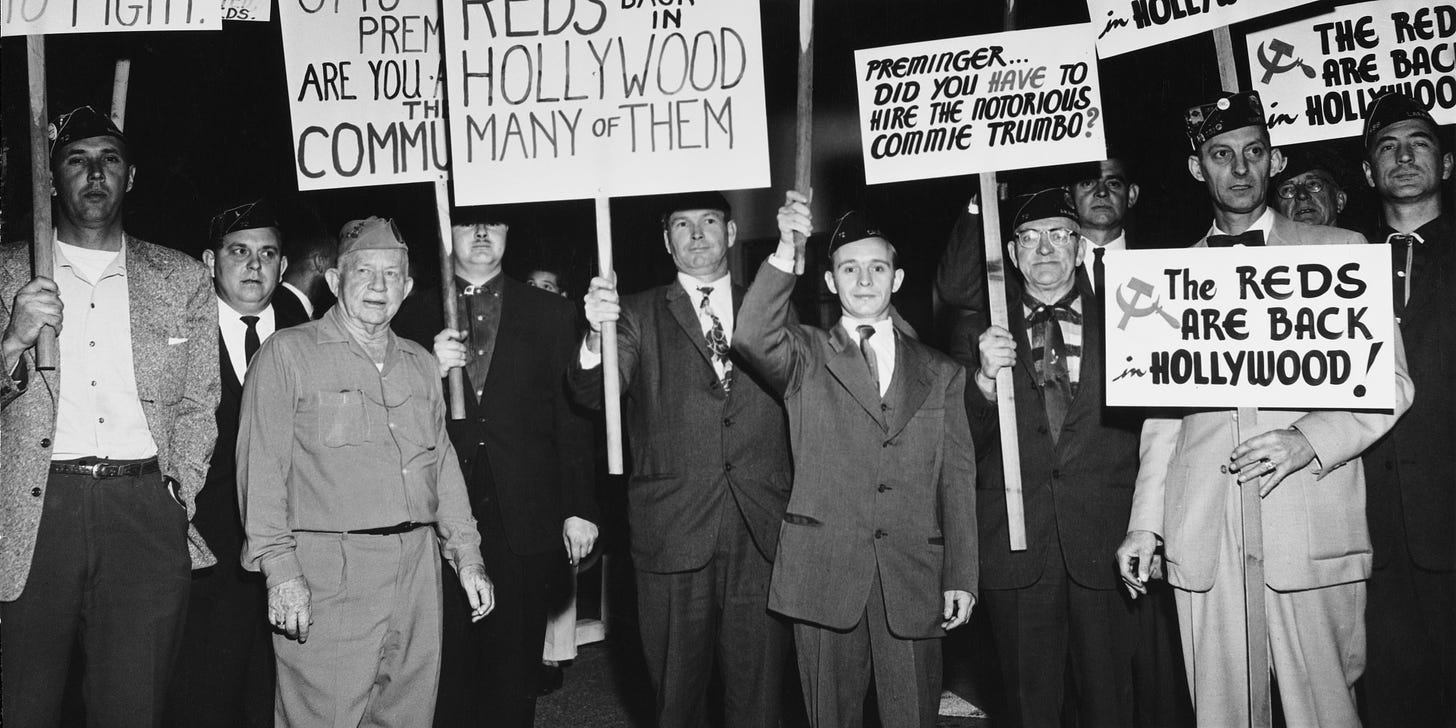 A group of protesters demonstrate holding placards against Communist sympathizers outside the Fox Wilshire Theatre in occasion of the premiere of film 'Exodus', which marked the end of the 'Hollywood Blacklist' when screen player Dalton Trumbo, a Communist Party member from 1943 to 1948 and member of the Hollywood Ten, was credited as the screenwriter of the film, Beverly Hills, Los Angeles, California, US, December 1960. (Photo by American Stock Archive/Archive Photos/Getty Images)