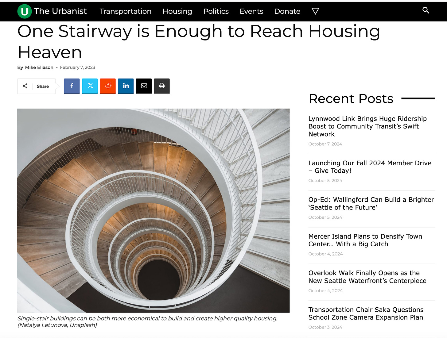 A screenshot of an article from The Urbanist site. Headline: One Stairway is Enough to Reach Housing Heaven. Photo of an interior circular staircase