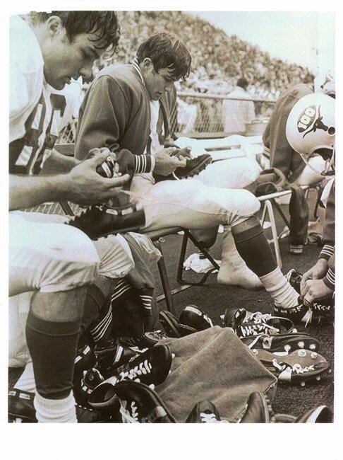 Mike and Tom trying to find a pair of shoes during the Big shoot-out that would get traction on Arkansas wet turf during the Big Shoot-out.