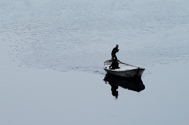 A person in a boat on the water

Description automatically generated