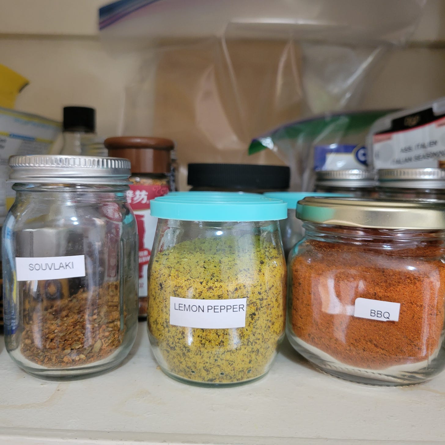 three class jars with labels for souvlaki, lemon pepper and bbq