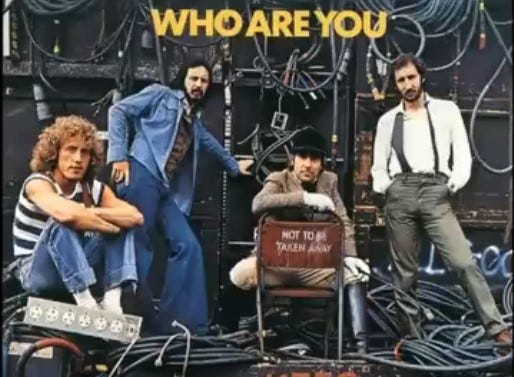 a late-1960s ear rock band poses under the words WHO ARE YOU?