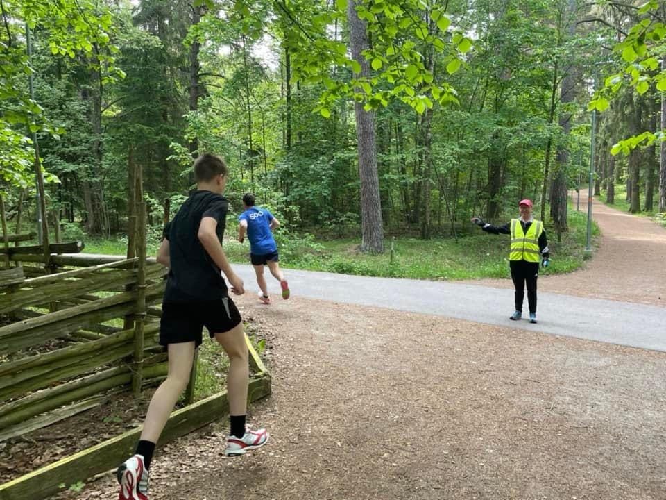 A marshal in hi-viz at the junction of several paths.