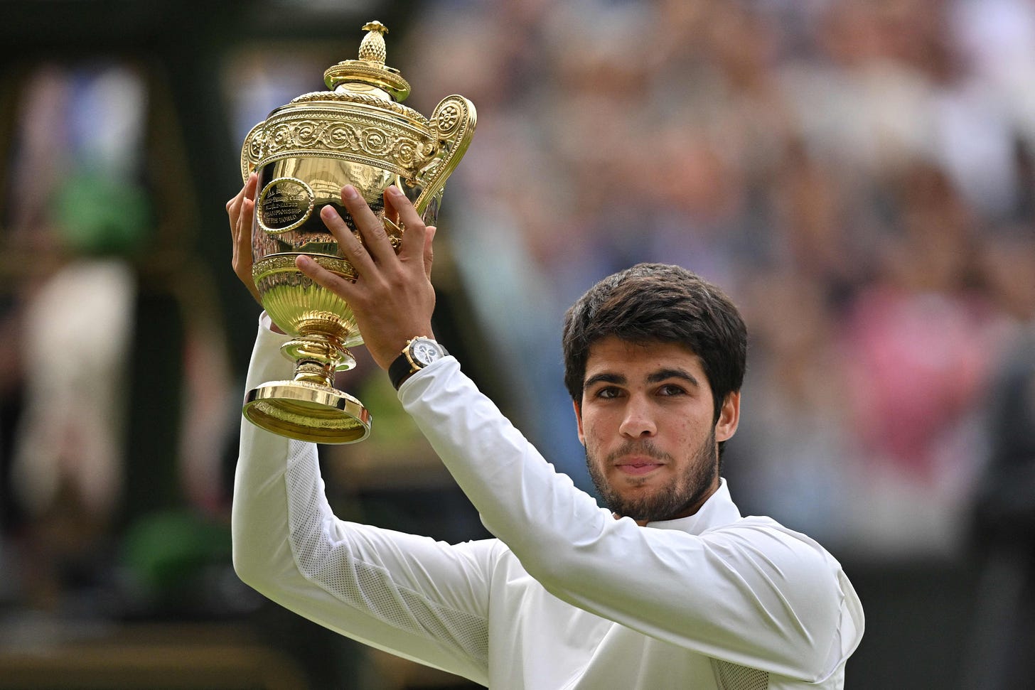 Spain's Carlos Alcaraz raises his trophy after beating Serbia's Novak Djokovic during their men's singles final tennis match on the last day of the 2023 Wimbledon Championships at The All England Tennis Club in Wimbledon, southwest London, on July 16, 2023. (Photo by Glyn KIRK / AFP) / RESTRICTED TO EDITORIAL USE