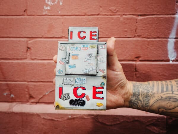 A miniature icebox, held by the artist.