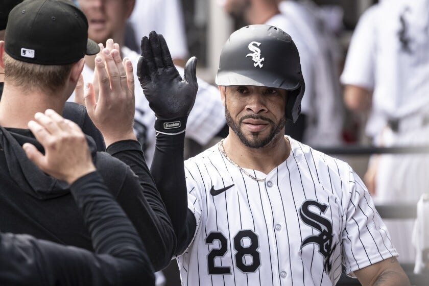Chicago White Sox center fielder Tommy Pham high-fives members of the Tampa Bay Rays