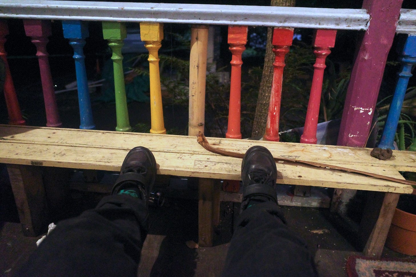 Robbie's feet at the front porch of the halfway, with rainbow painted balcony