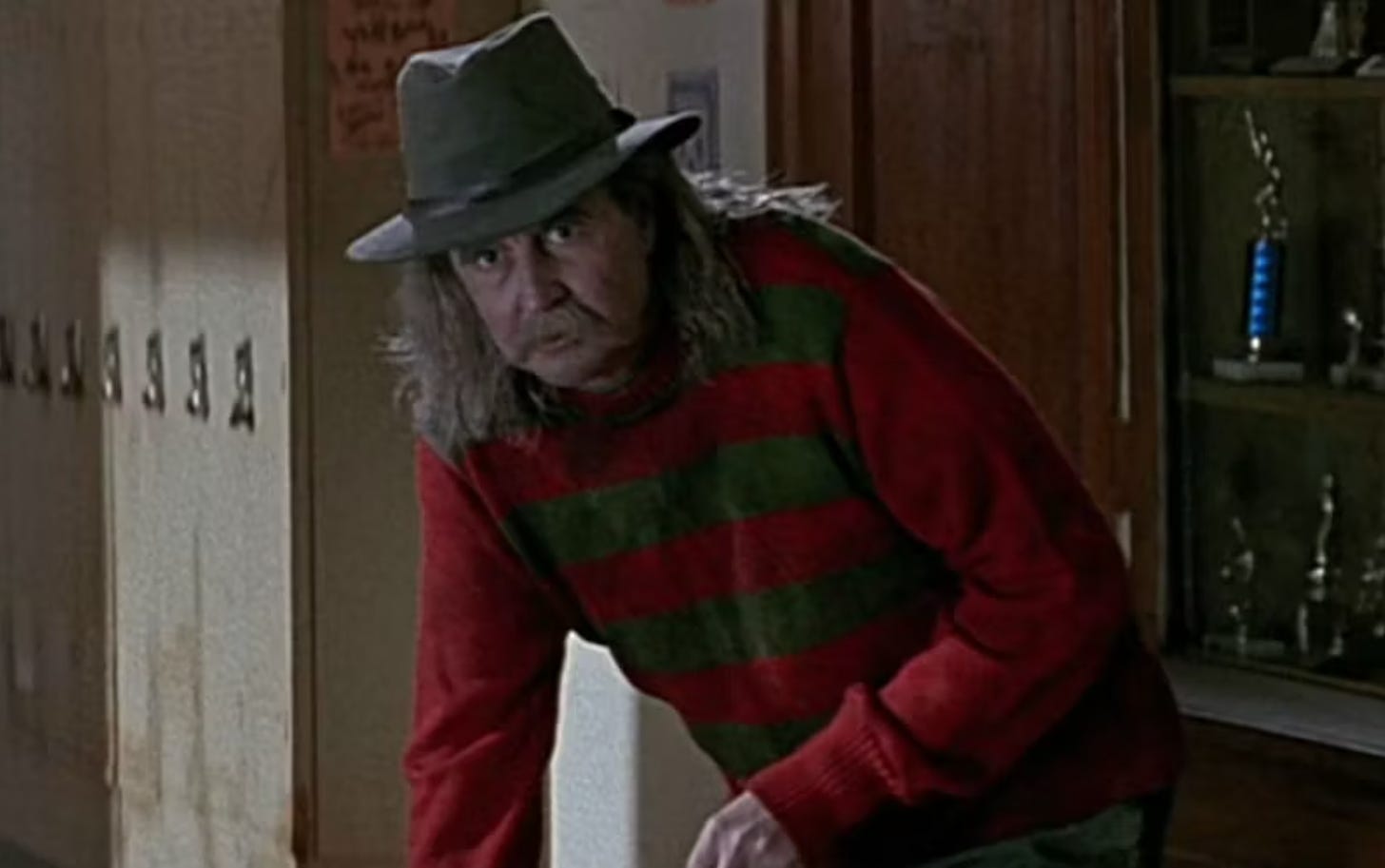 Wes Craven as a janitor dressed as Freddy Krueger in Scream.