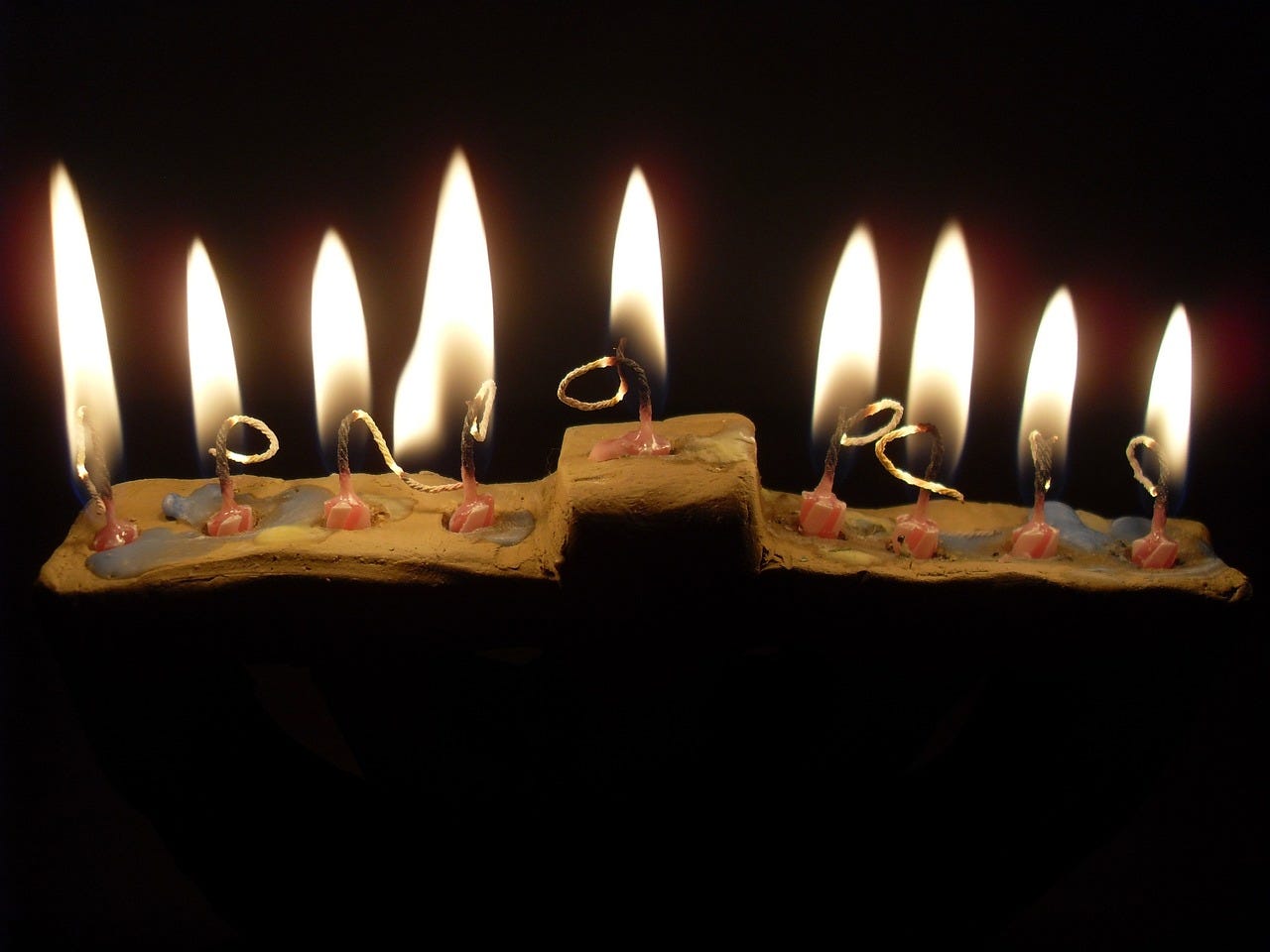 a hanukkah menorah lit with candles