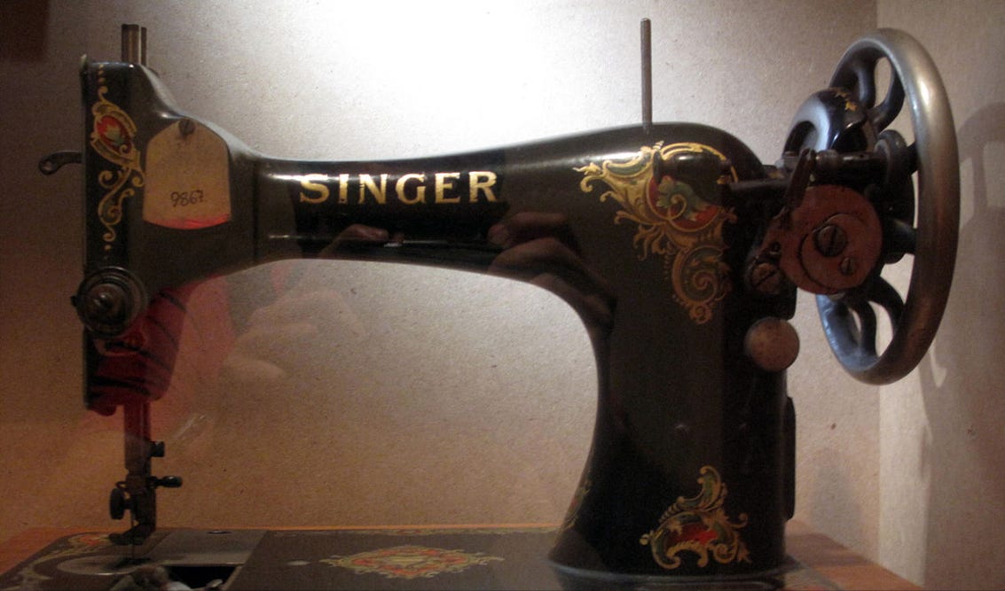 A Singer sewing machine painted in black and gold