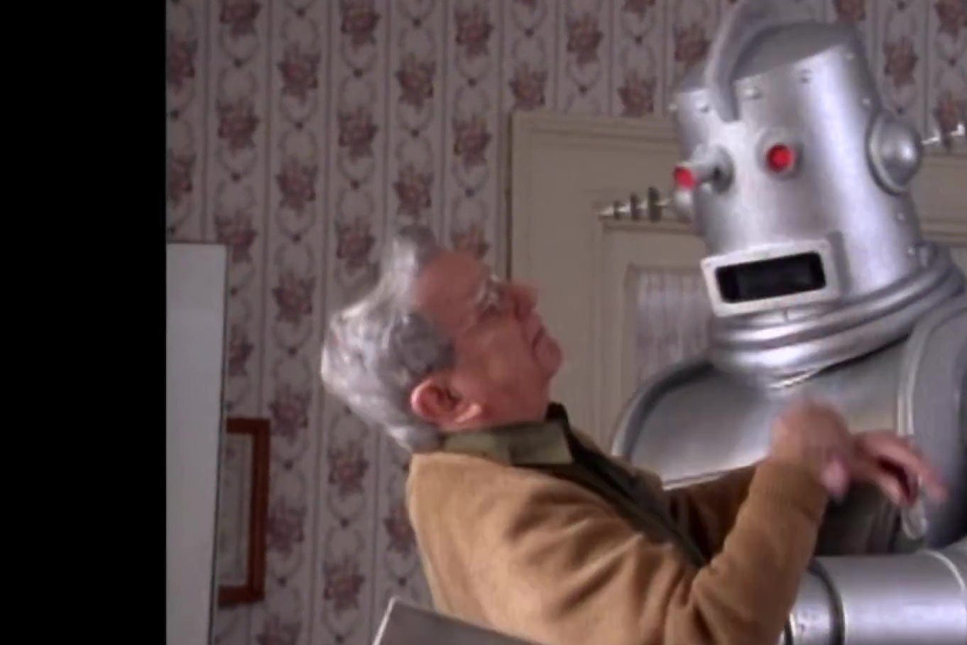 An elderly man is attacked by a robot.