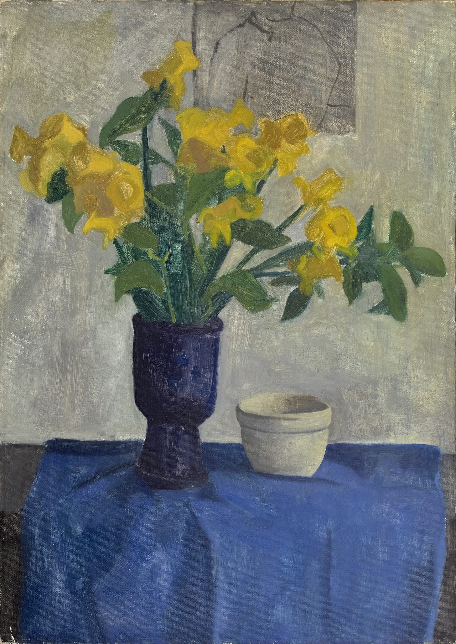 A still life with daffodils in a blue ceramic vase on a table with a cloth and white bowl. Behind, on the wall, is a charcoal sketch of a partial seated figure.