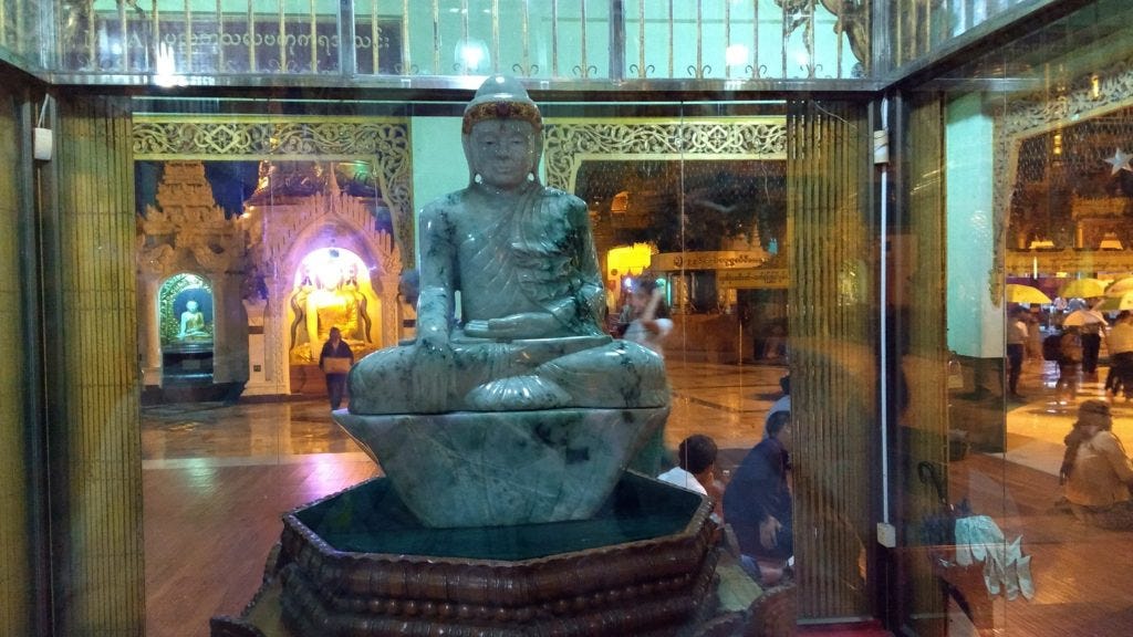 Jade Buddha behind glass