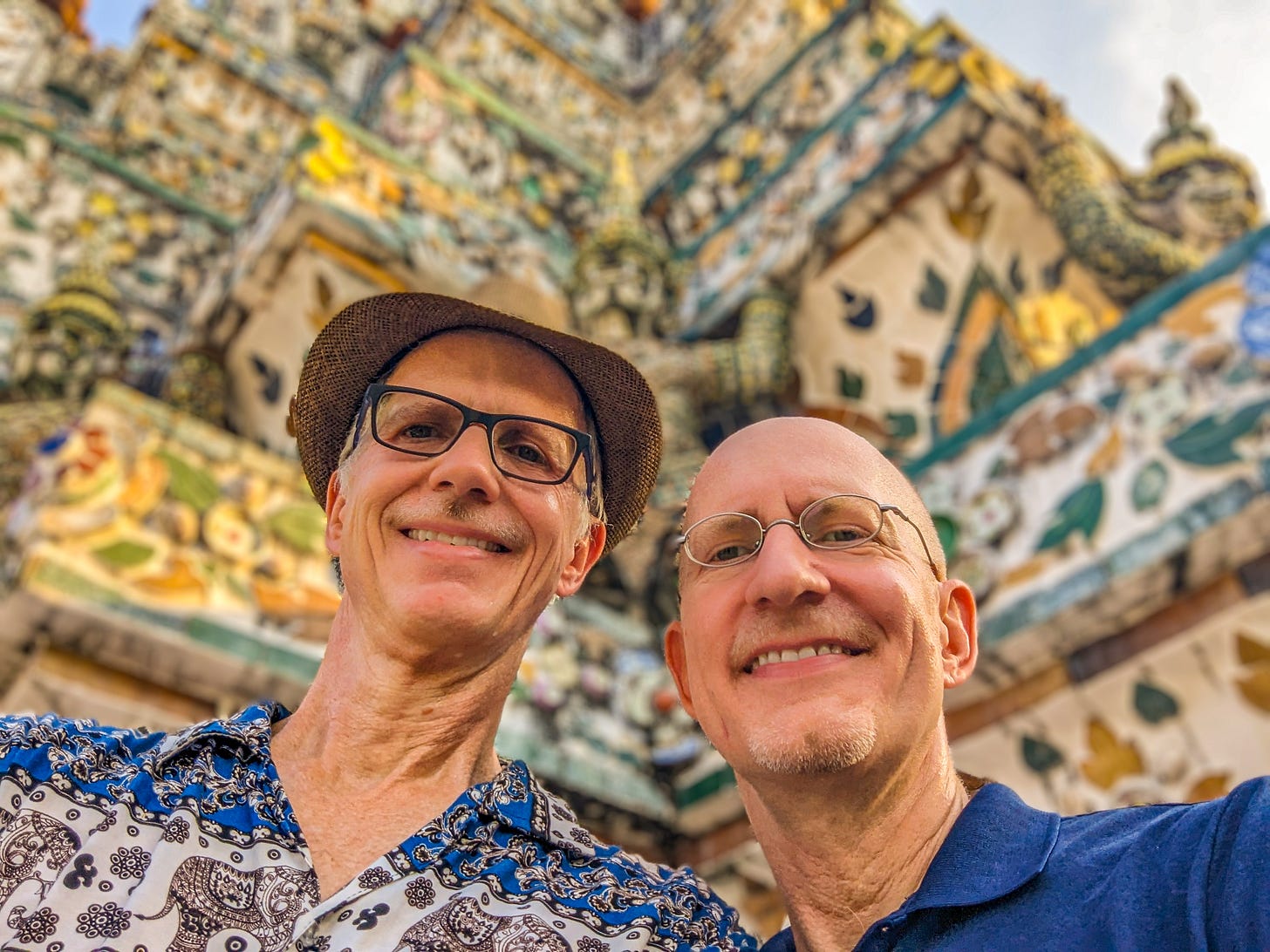 A smiling Brent and Michael posing in front of Arun Wat.