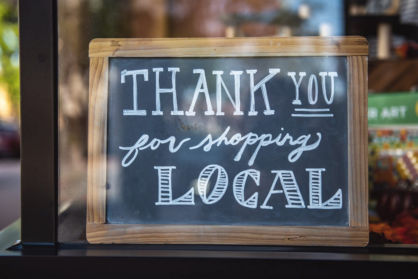 sign says thank you for shopping local