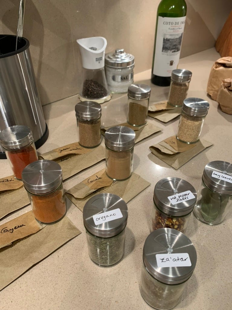 The spice jars, some with labels, some still to be labeled