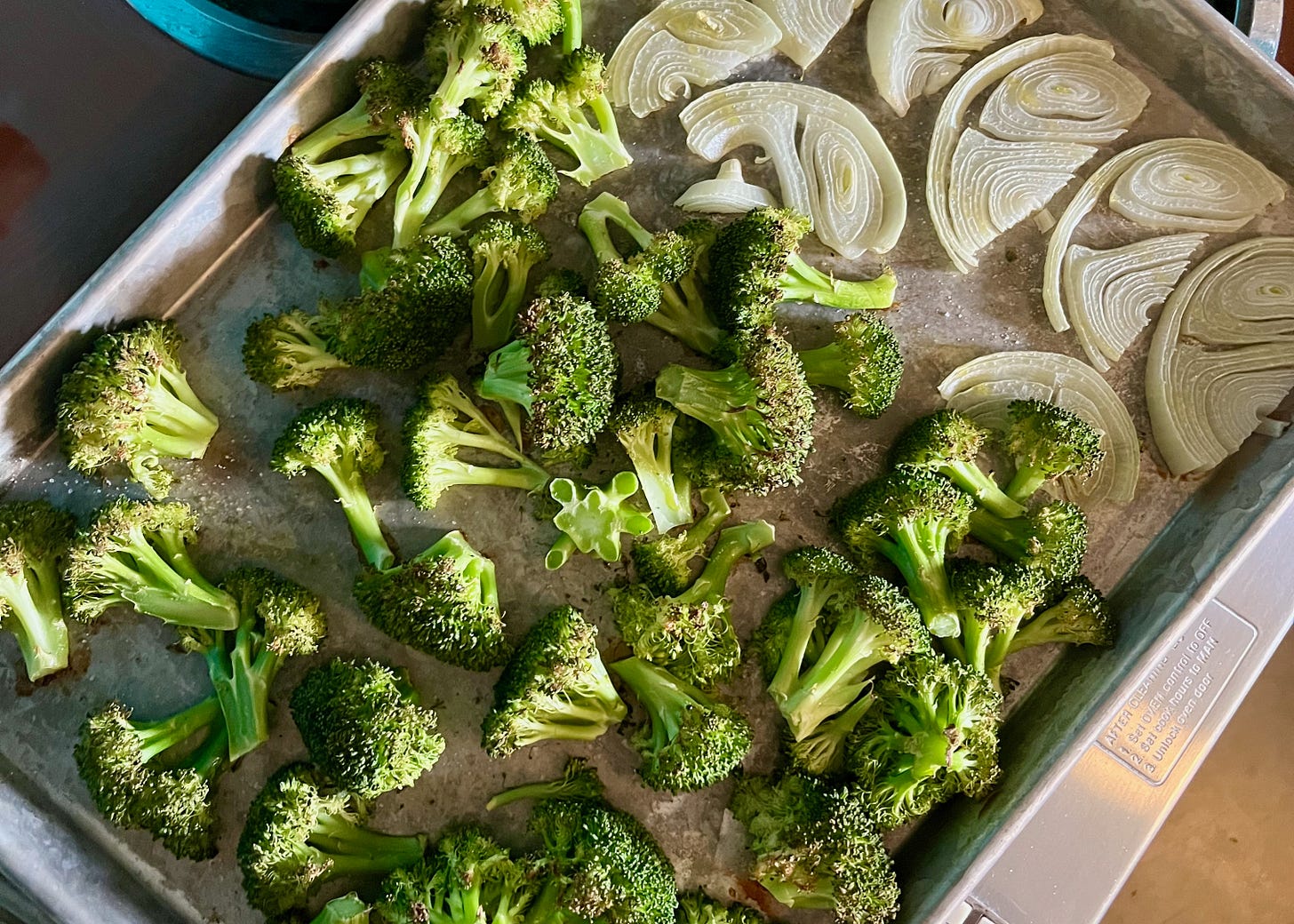 a pan of roasted broccoli and onions