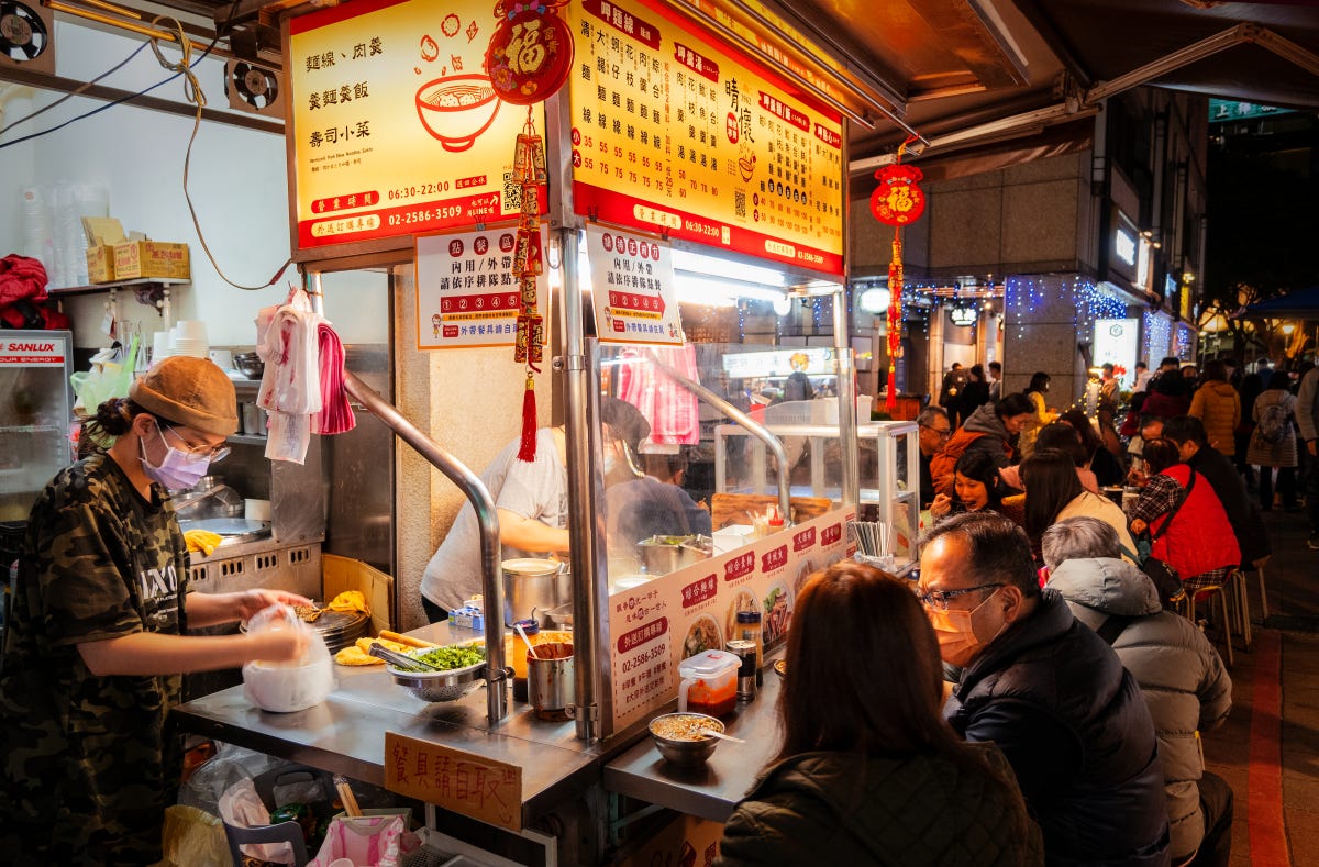 Seats are packed at a popular vendor of squid stew at Taipei's Shuangcheng jie night market