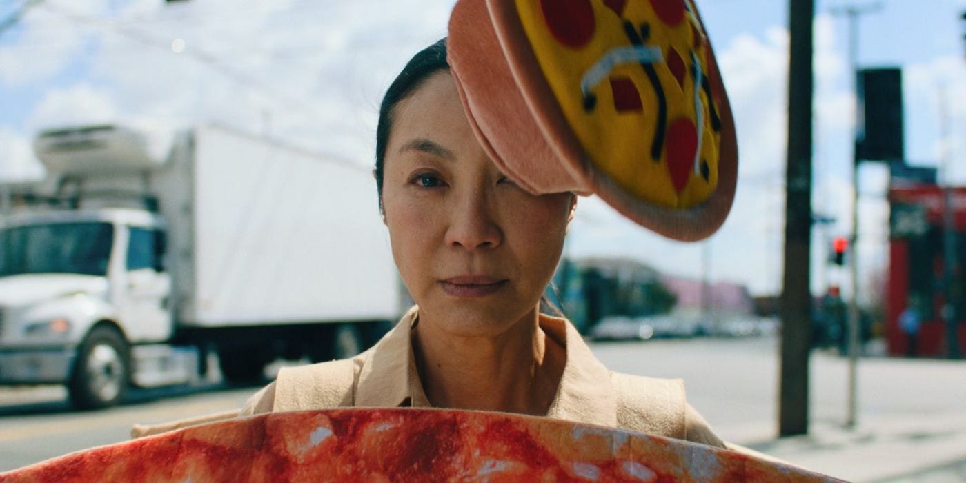 Evelyn Wang as a pizza place sign spinner - Everything Everywhere All At Once