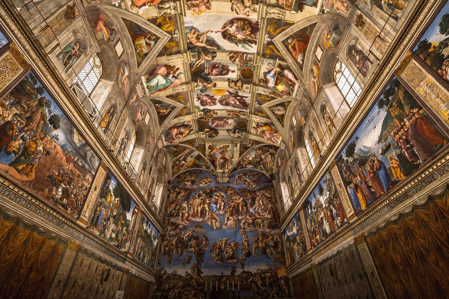 Foto interna da Capela Sistina, com destaque para os afrescos de Michelangelo.