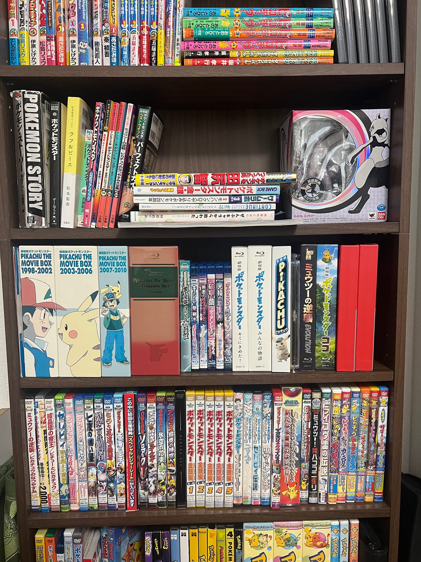 Dogasu has an impressive collection of Pokémon items! Here's a photograph of his Blu-rays and DVDs