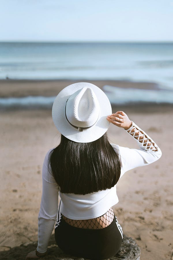 woman sitting by the sea