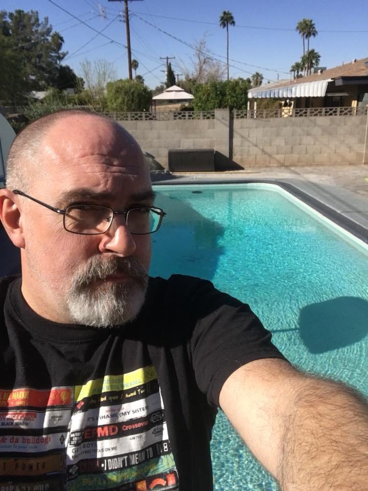 Brian Keene standing in front of a swimming pool in Arizona