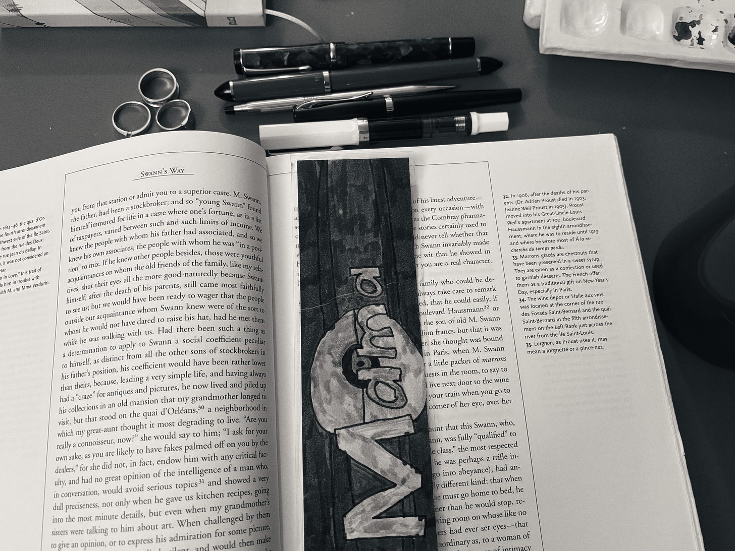 Proust book open on a table with a mama bookmark