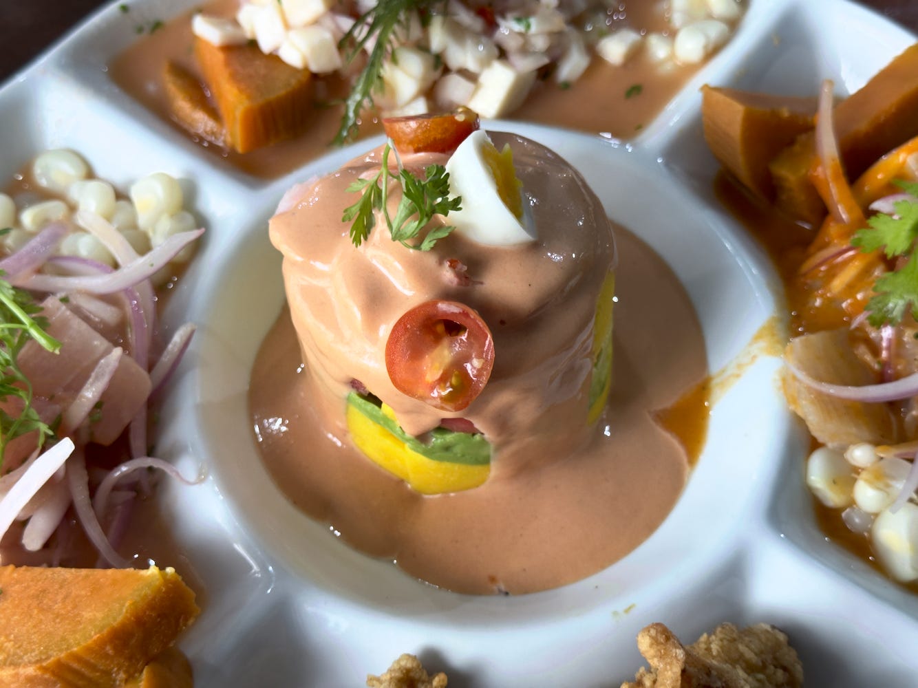 The shrimp salsa at the center of the ronda consists of layers of potato, shrimp, and avocado covered with golf sauce