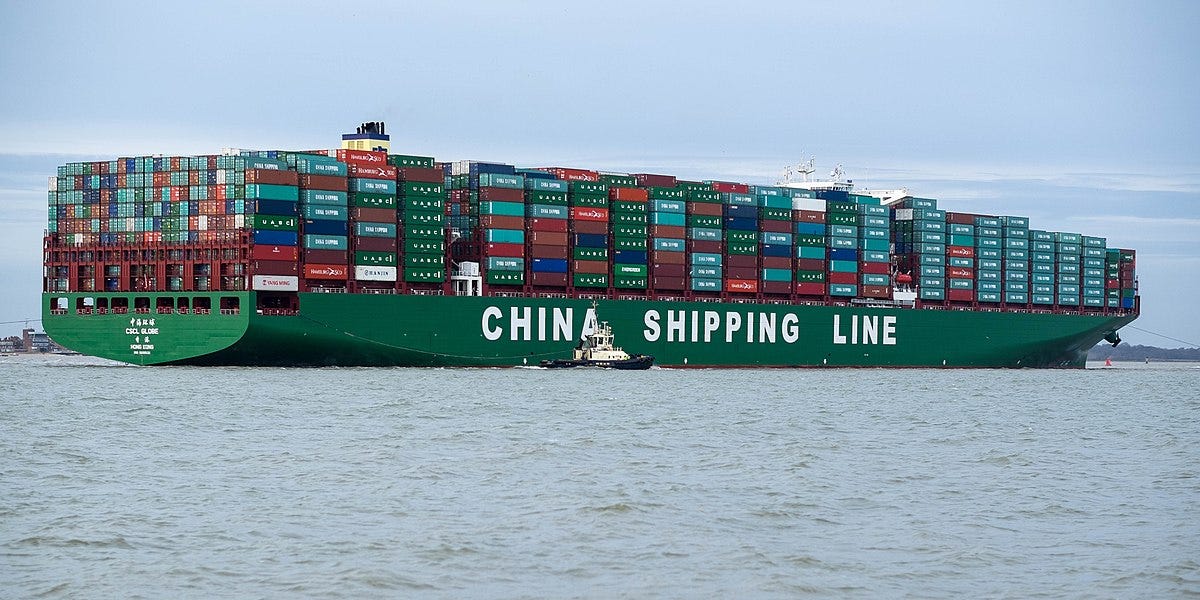 A large green China Shipping Line container ship, fully loaded with shipping containers.