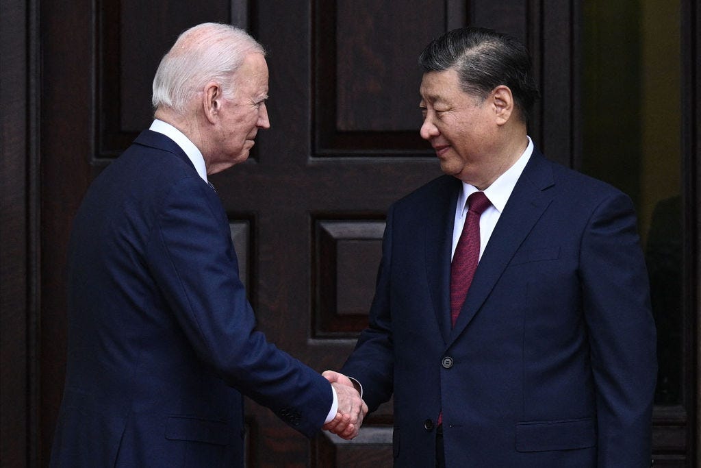 U.S. President Joe Biden and Chinese President Xi Jinping shake hands.