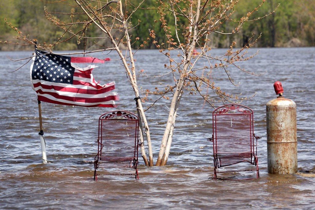 A flag is surrounded by floodwater at the Riverview RV Park on May 01, 2023 in Bellevue, Iowa. (Photo by Scott Olson/Getty Images)