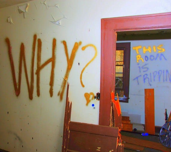 Photo of a wall with the question, "Why?"