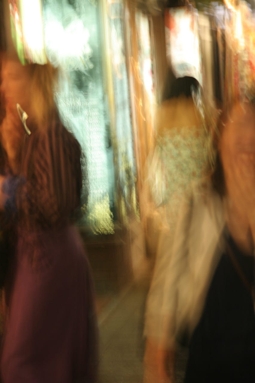 A blurry image of people walking

Description automatically generated