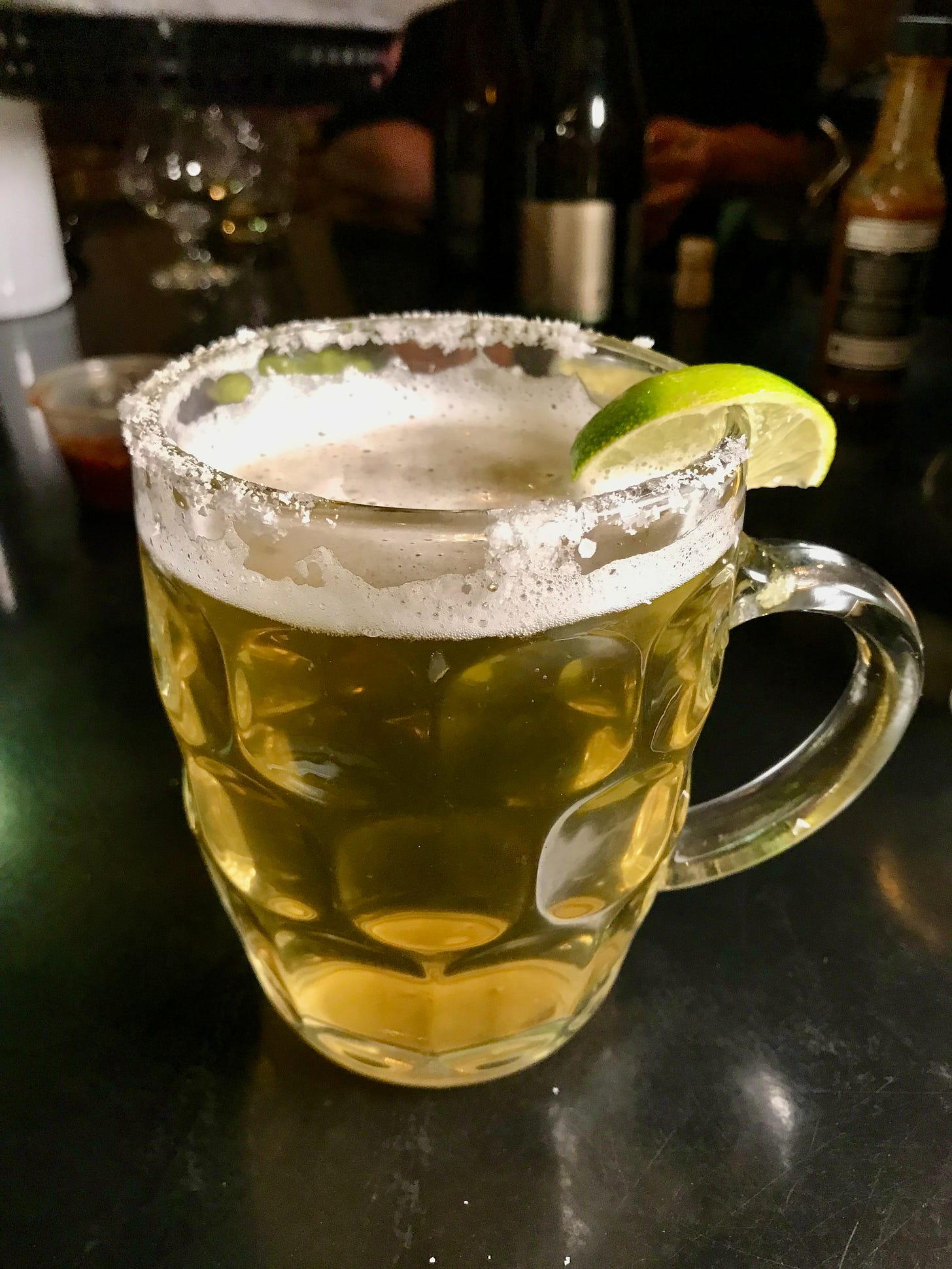 a mug of Mexican style lager with a salt rim and lime at Paradox Beer Company