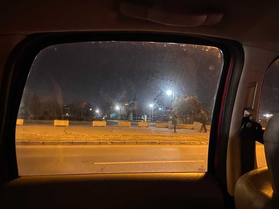A photo by Tim Murray-Browne showing the view out the car window of a street in Bucharest.