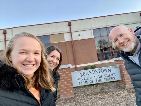 Superintendent Smith stands in front of Beardstown Middle and High School along with his daughter, Ashton (left), and his wife Shannon (right).